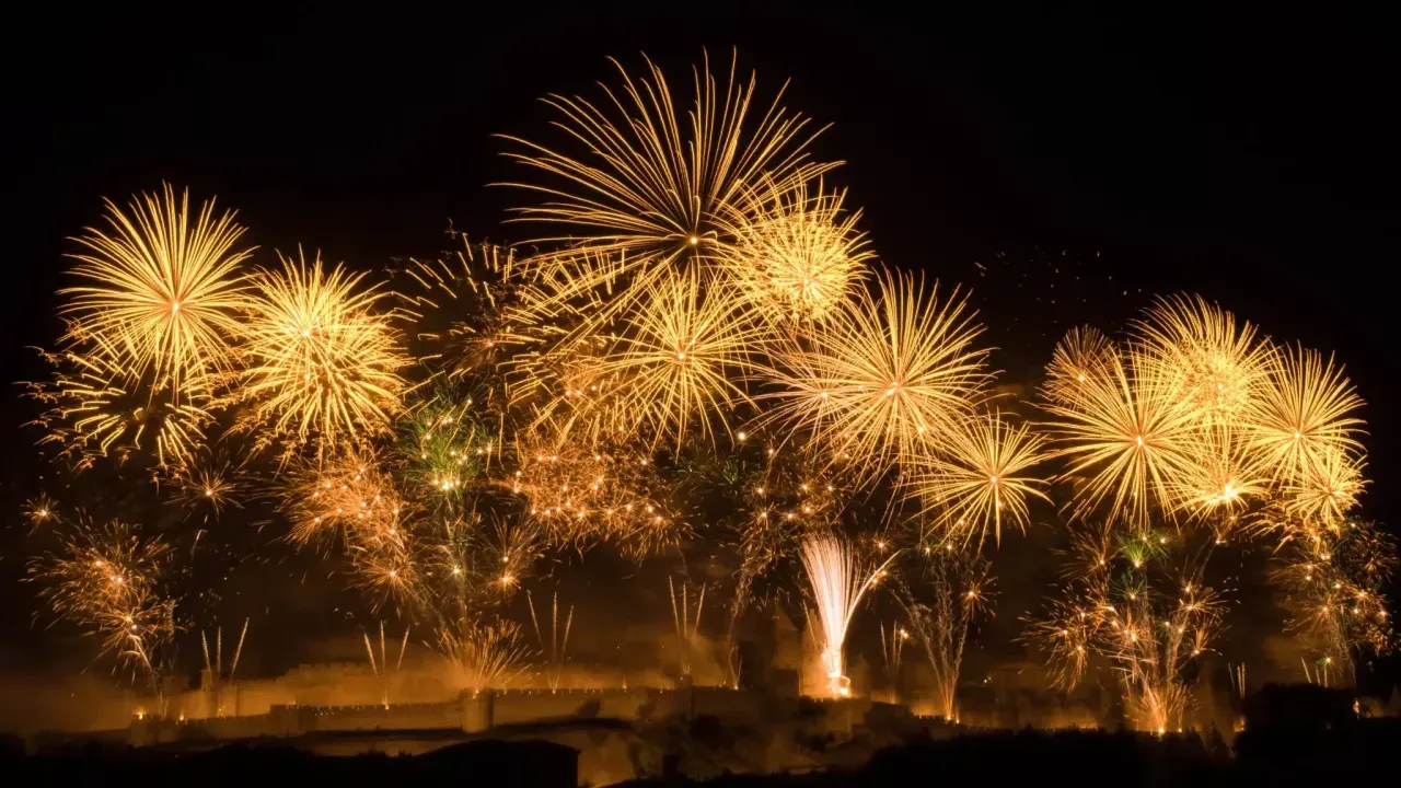 Golden fireworks against a dark sky.