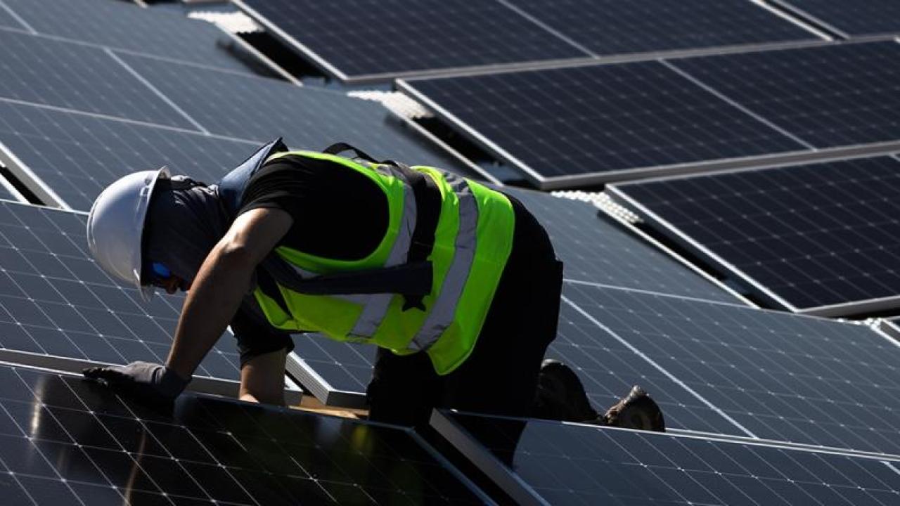 Worker installing polar panels  