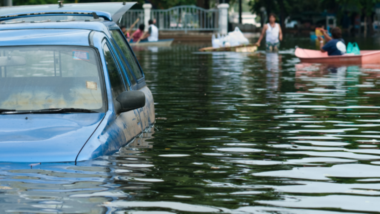 car sinking in a flooded street