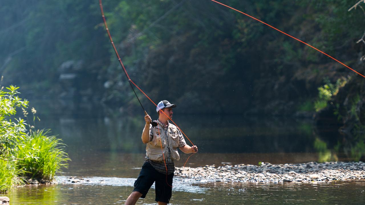 A person in a stream fly-fishing.