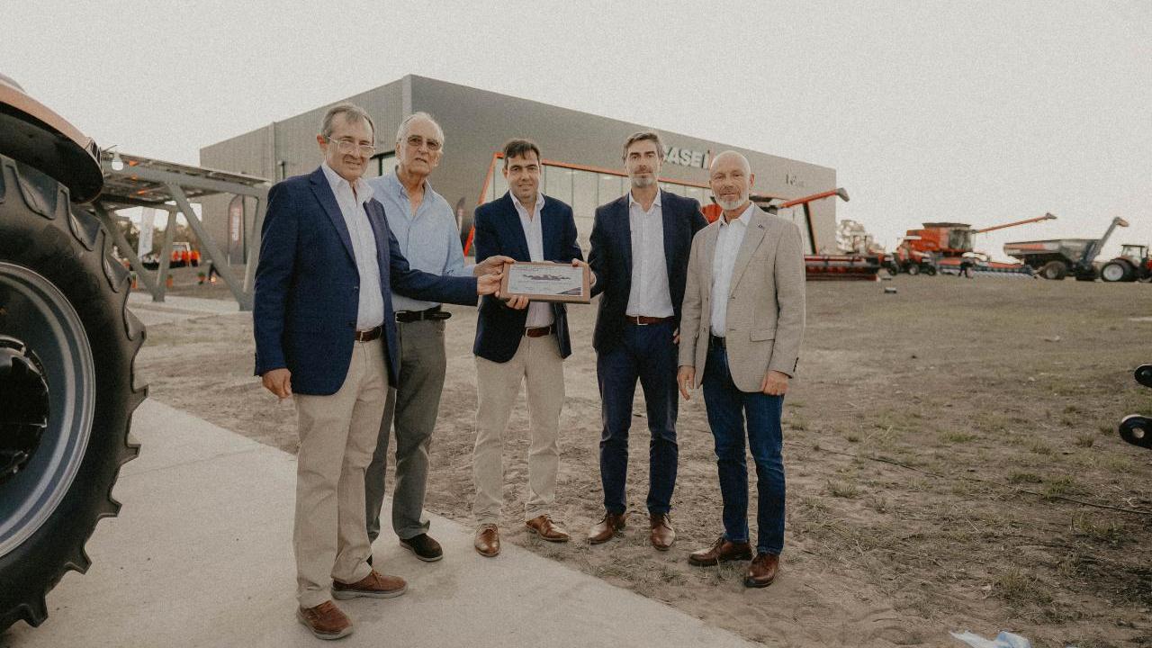 Five people standing together outside a dealership