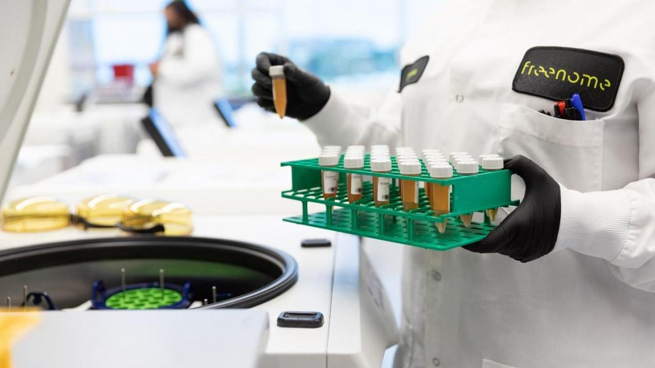 scientist holding tray of vials