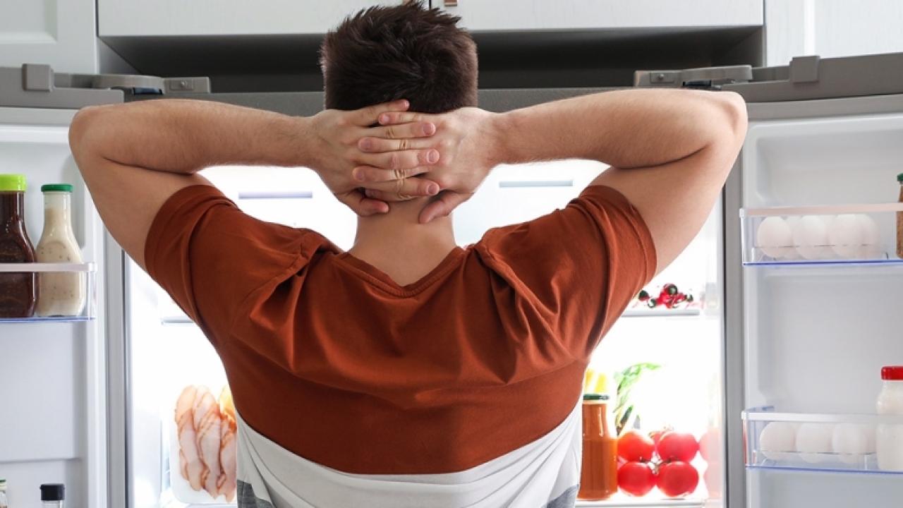 Person in front of open fridge