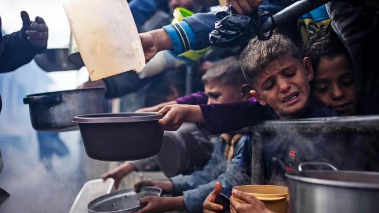 Palestinians line up for free meals in Rafah, Gaza, on Feb. 16. // Photo by Fatima Shbair / AP file