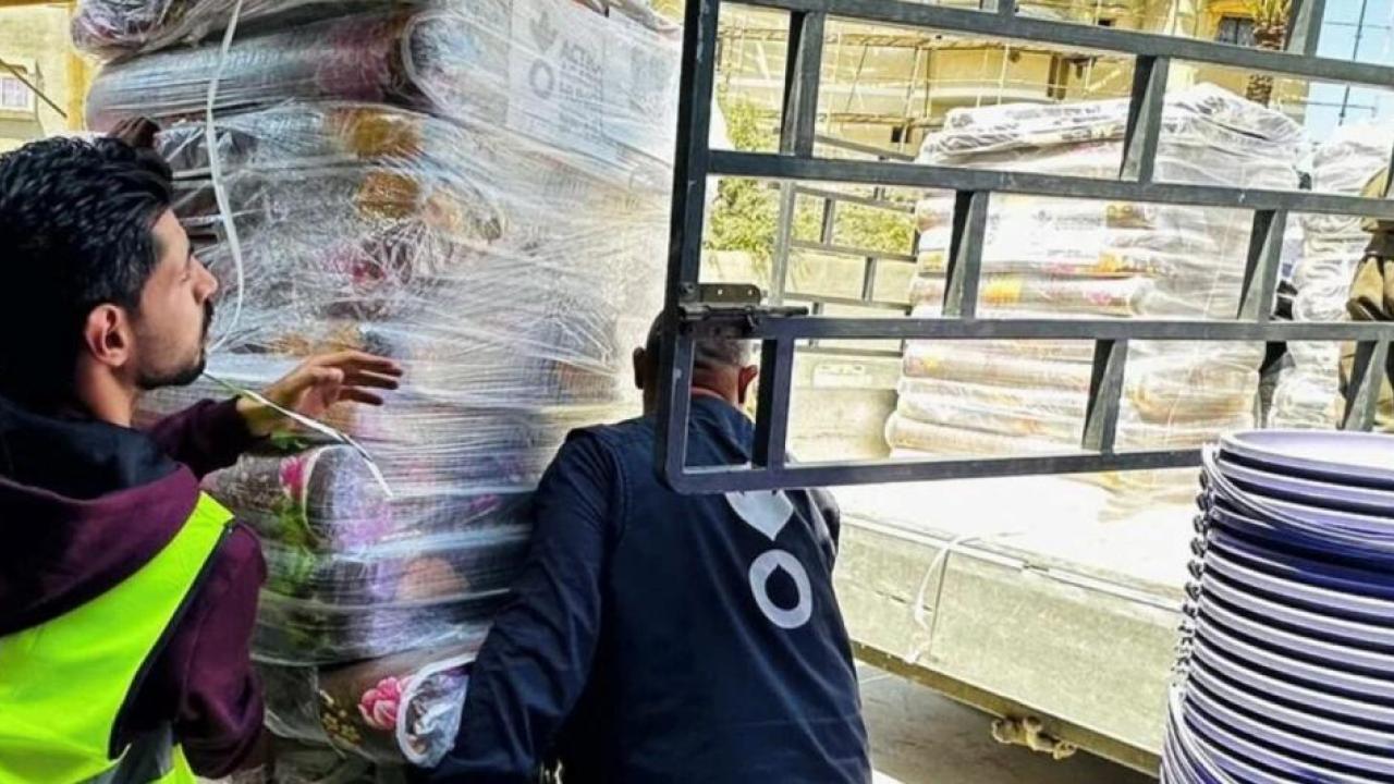 workers carrying a pallet of supplies