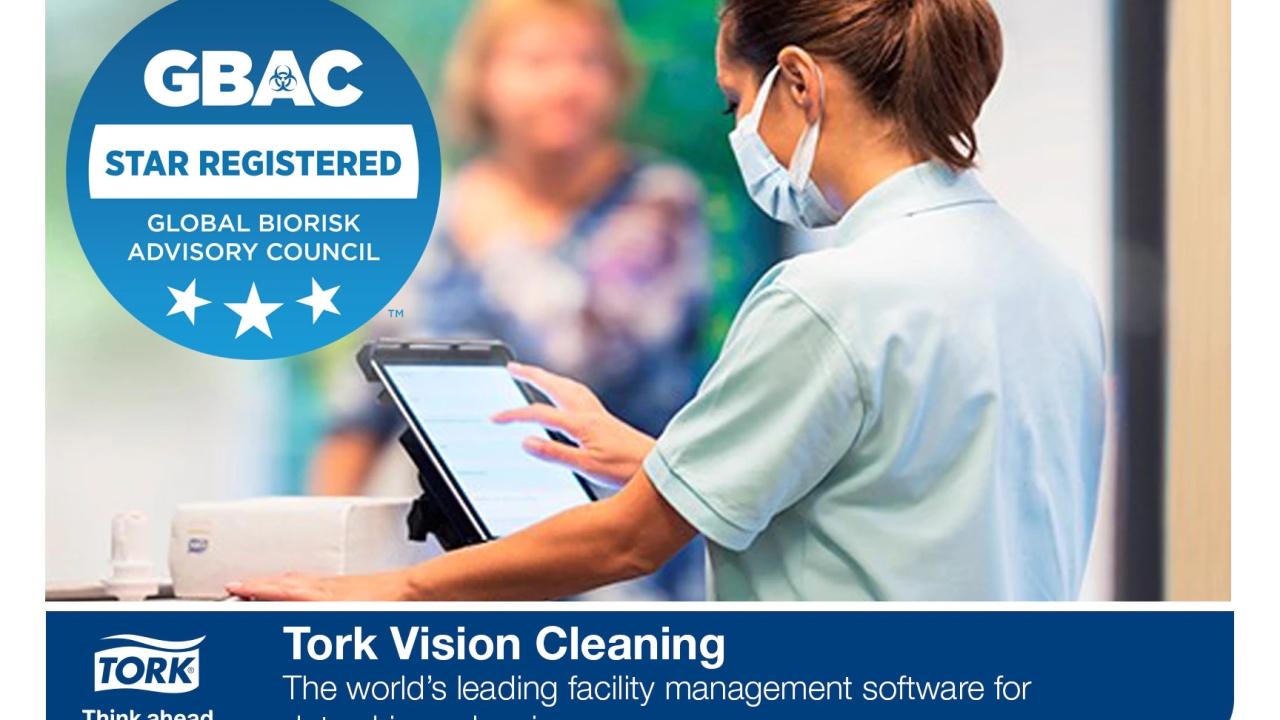 GBAC STAR registered logo and Tork Vision Cleaning banner at the bottom. A healthcare provider uses a touch screen device