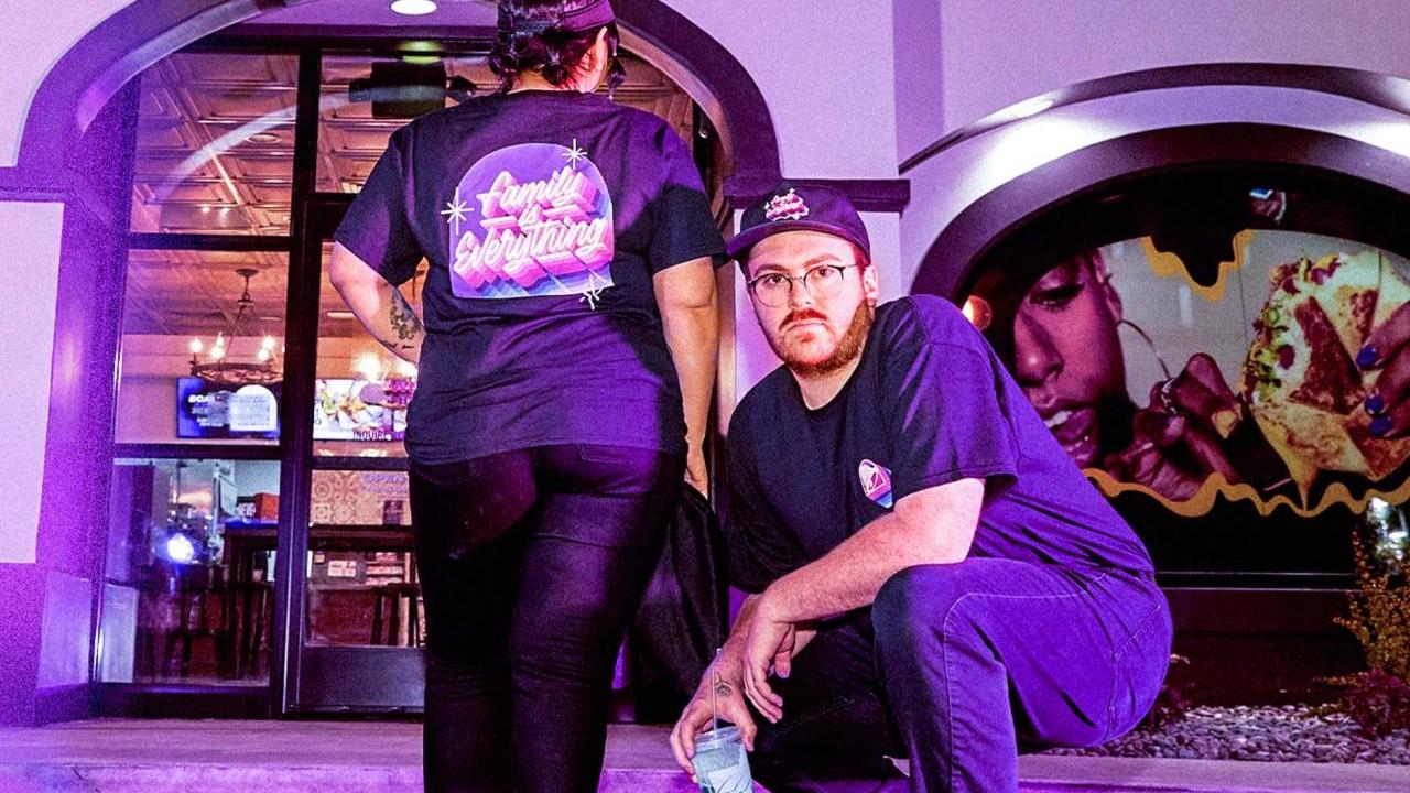2 people posing in exclusive team gear