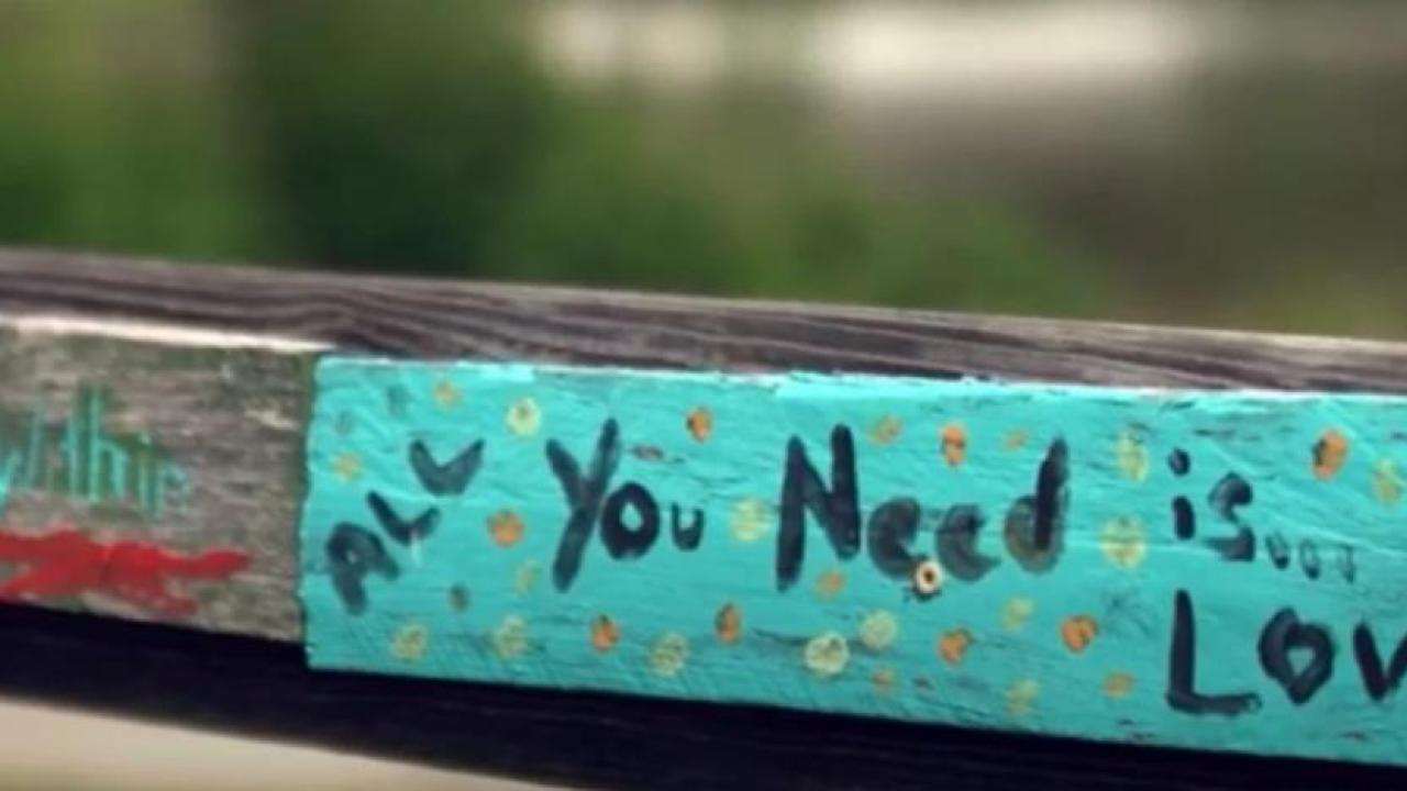 board painted with the words "all you need is love"