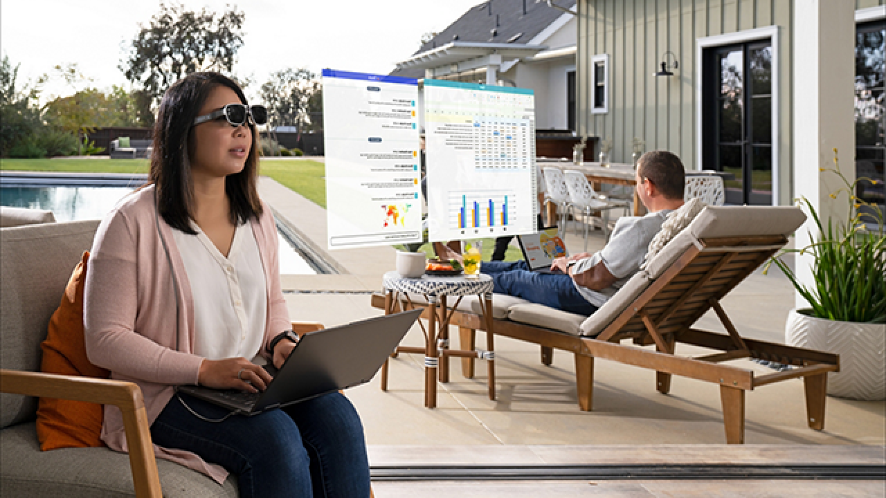 Woman in AR glasses looking at screens