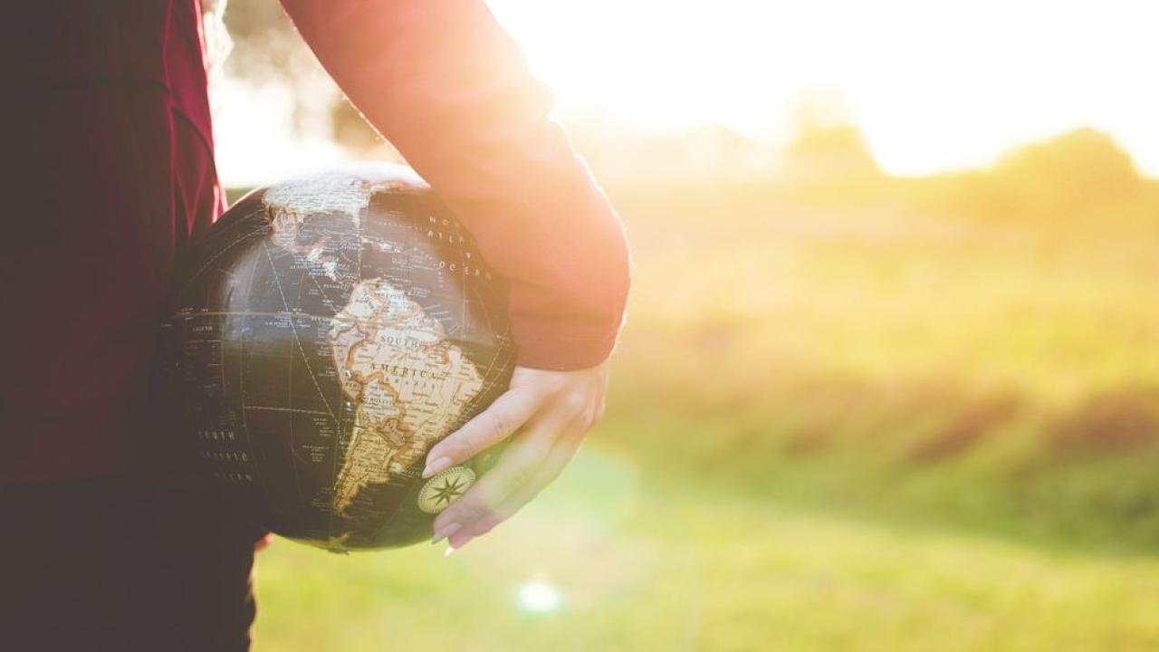 A person holding a globe 