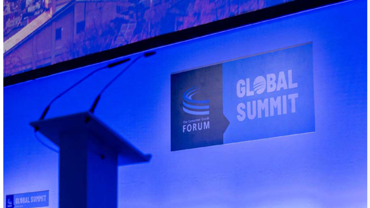 An empty podium on a stage. "Global Summit" and The consumer goods forum logo behind it.