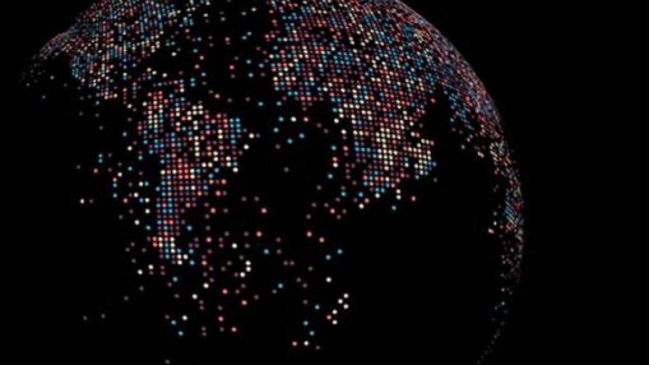 A dark globe on a black background. Countries lit up with pixels of different colors.
