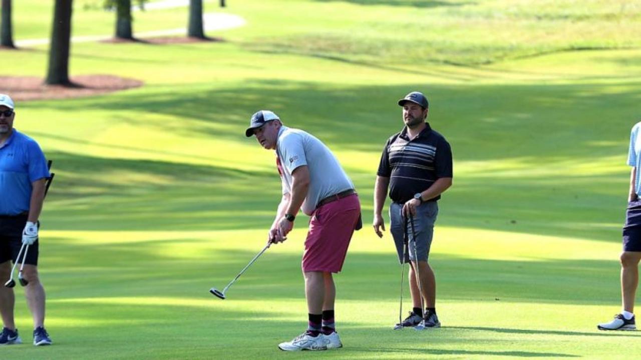 Four golfers on the course.