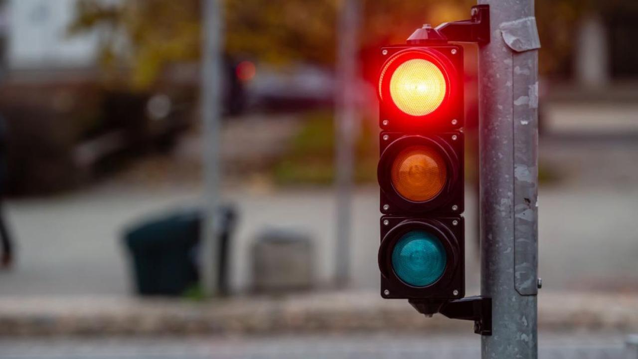 A stoplight shining red.