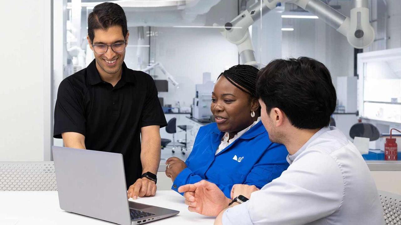 people looking at a laptop together