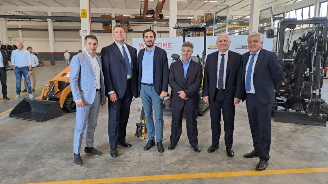 6 people standing together in a factory