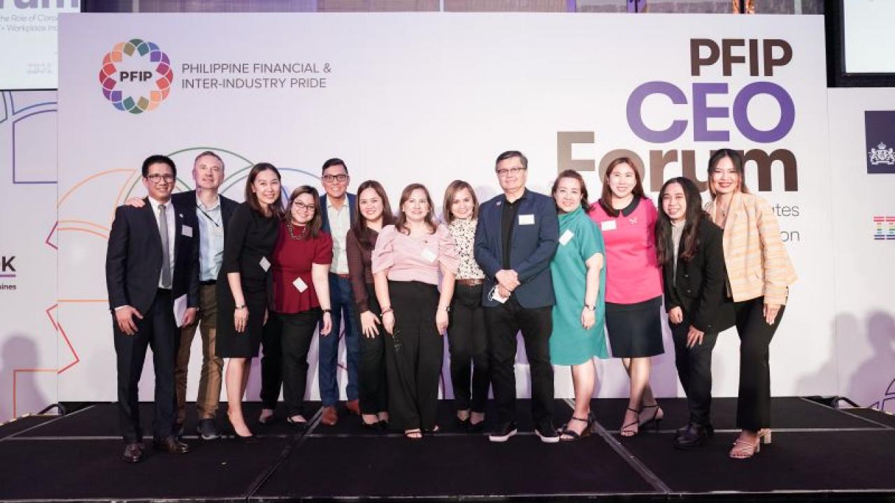 A group of people posed for the camera. Large "PFIP CEO Forum" sign behind them.