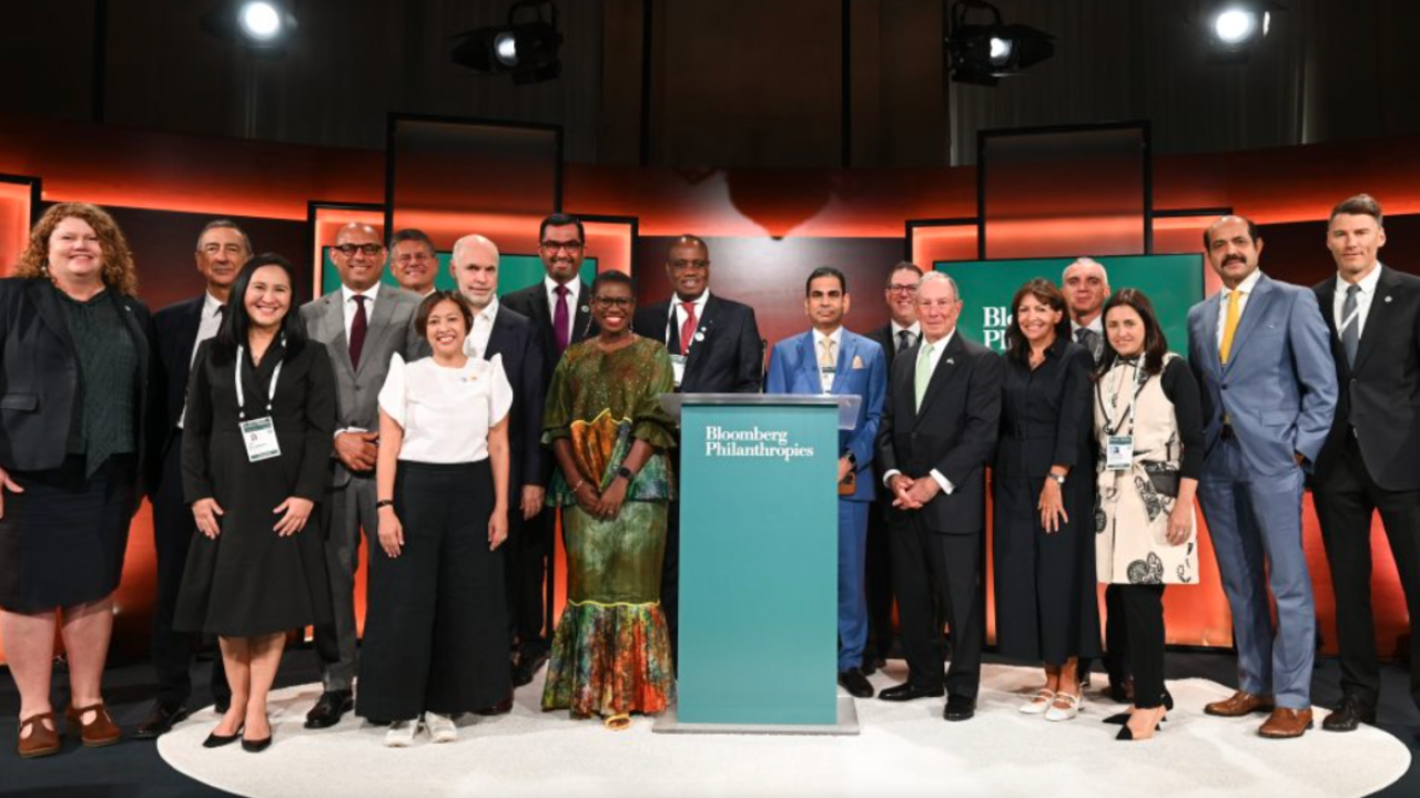 group photo in front of the Bloomberg Philanthropy lectern