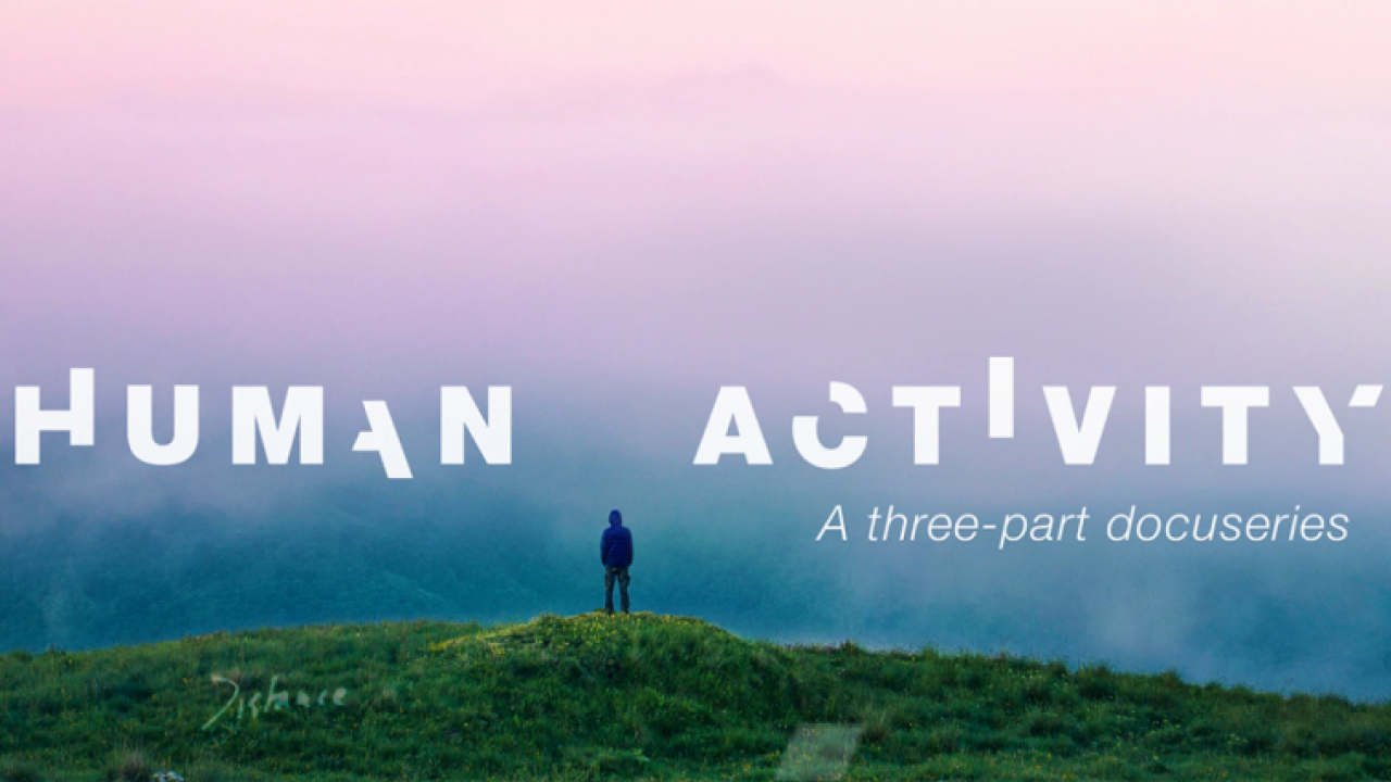 Human Activity, with a pink mist over a grassy hill with one person standing atop it