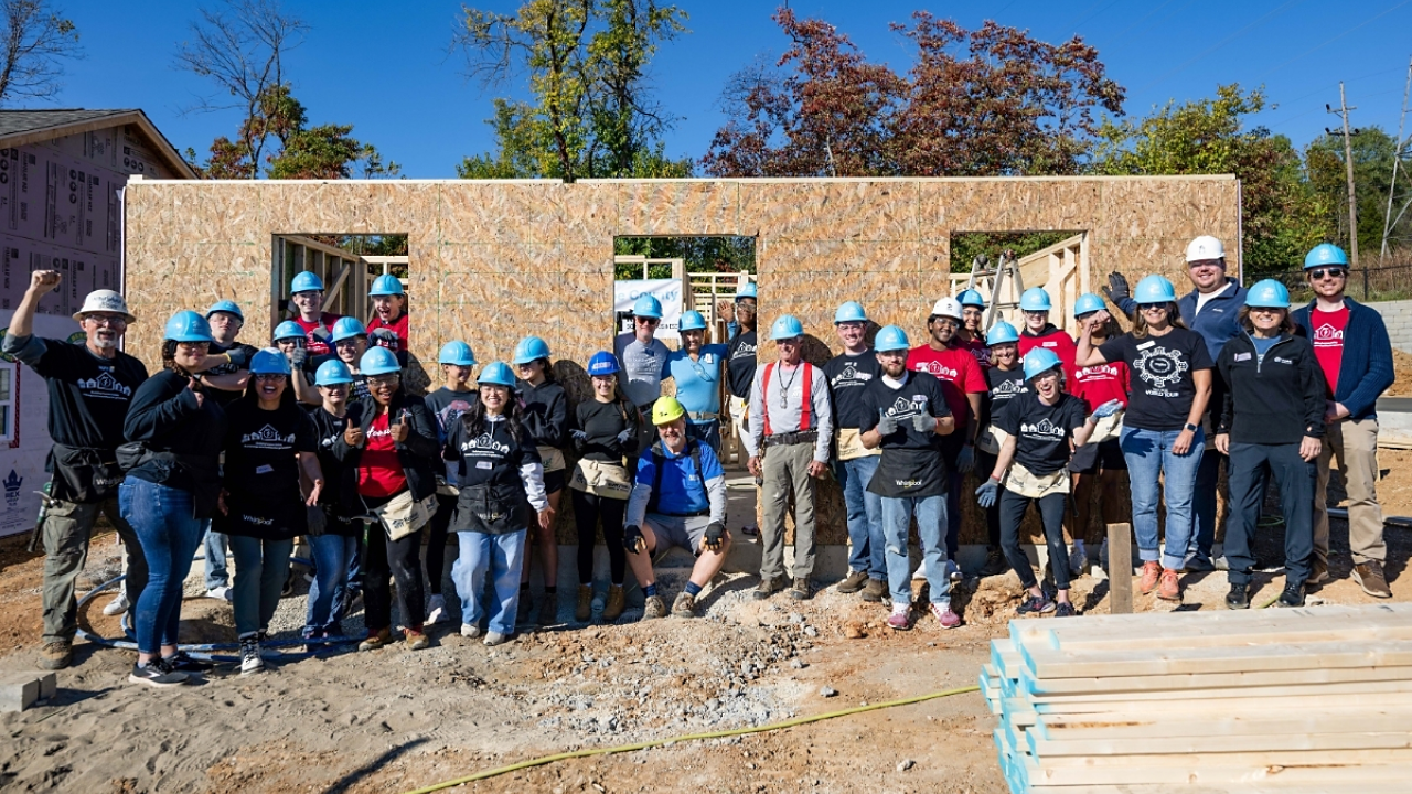 A group of volunteers outside a home being built