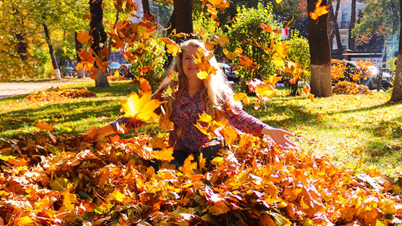 person playing in a pile of leaves