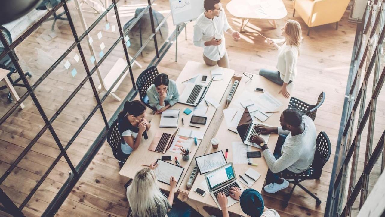 Aerial view of people working at a desk together
