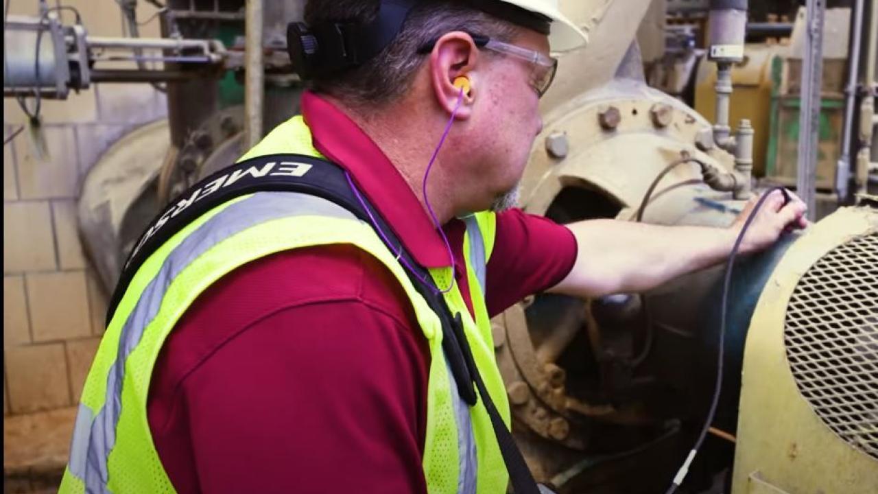 Worker in hard hat at a machine