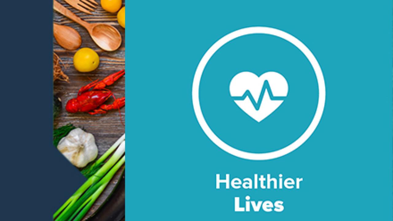 "Healthier lives" and logo. On the side a board of utensils, lobster, garlic and other produce.
