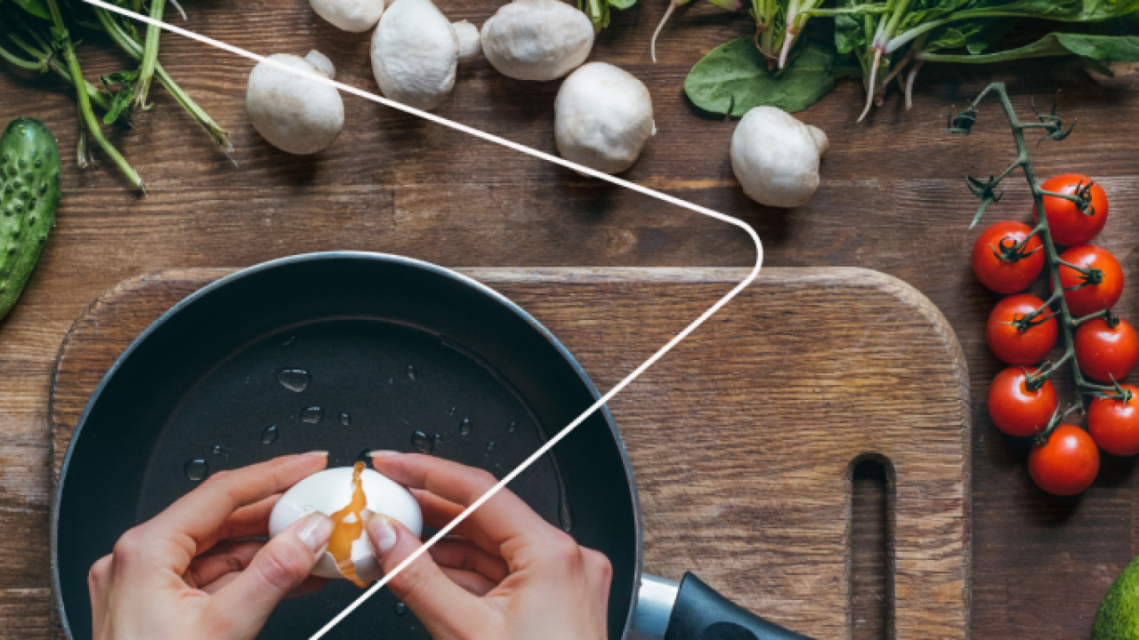Cracking an egg over a skillet