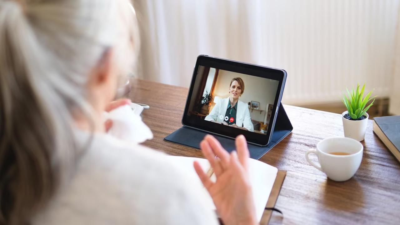 A person having a video call on a tablet device 
