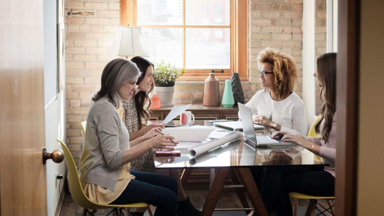 4 people sitting at a meeting