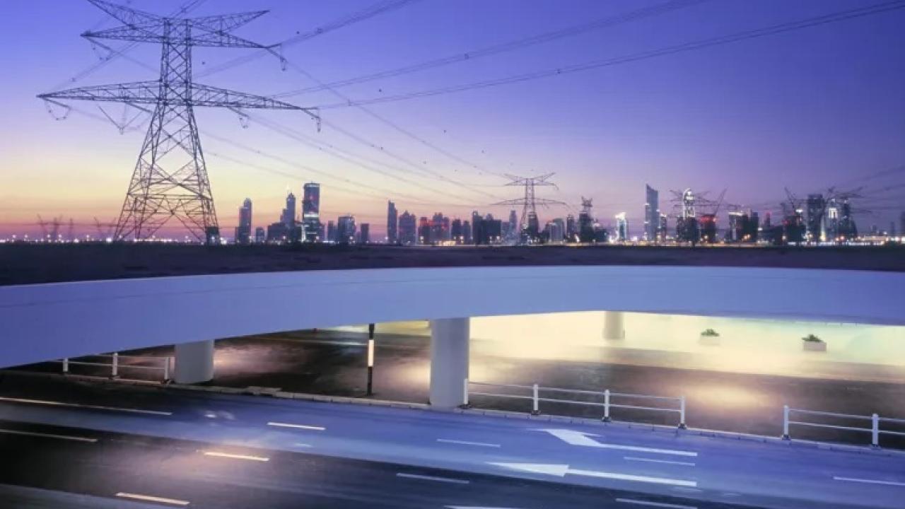 transmission tower with a city skyline in the background
