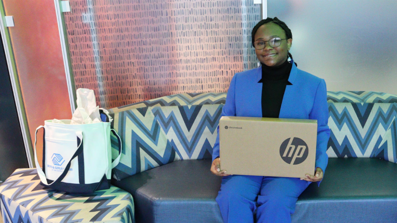 Person on couch holding HP Box