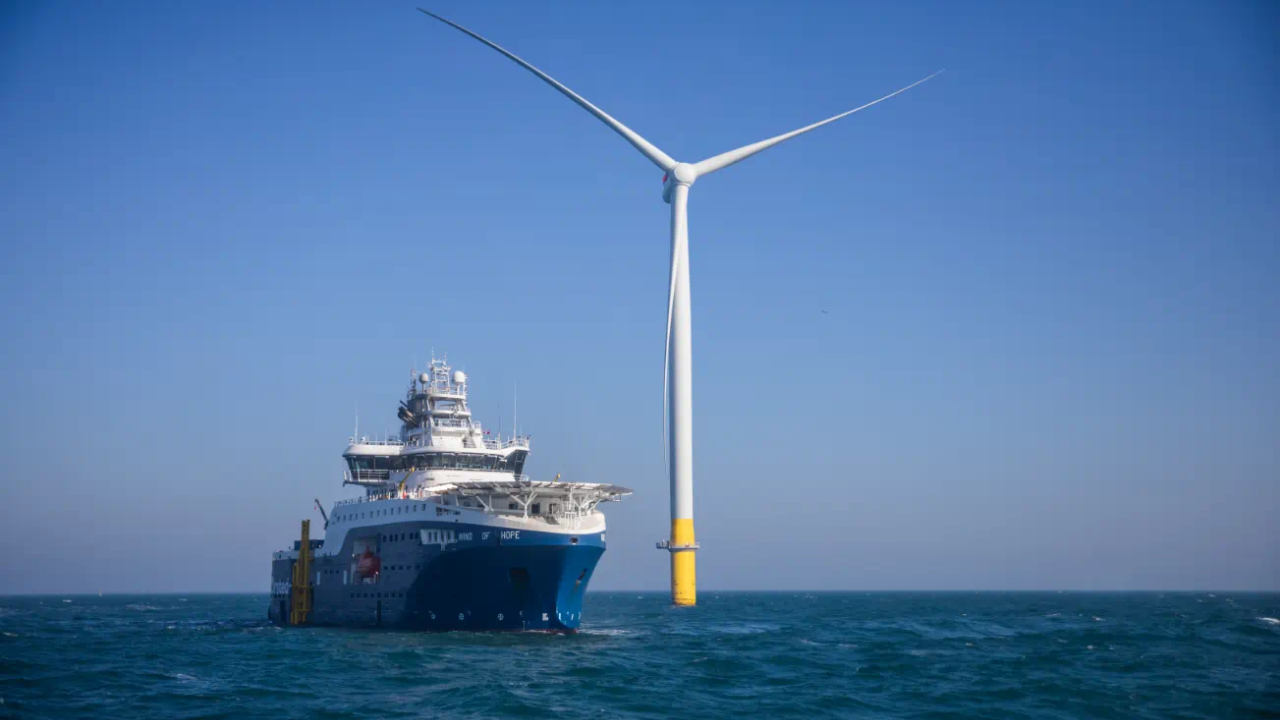 Ship going by a wind turbine at sea