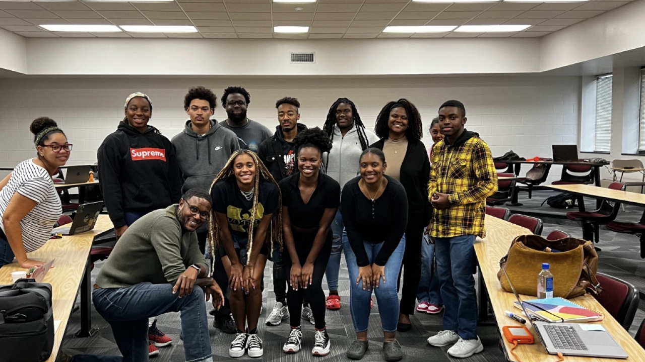 Students all standing in a group smiling at the camera 