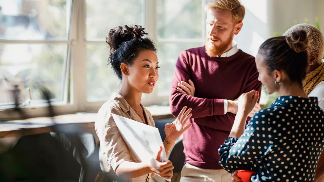 3 people talking in an office setting