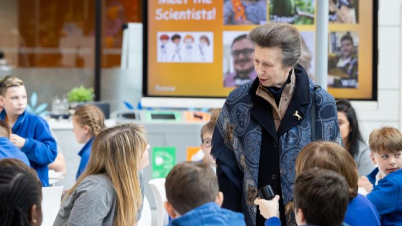 HRH Anne shown with children on DNA Day.