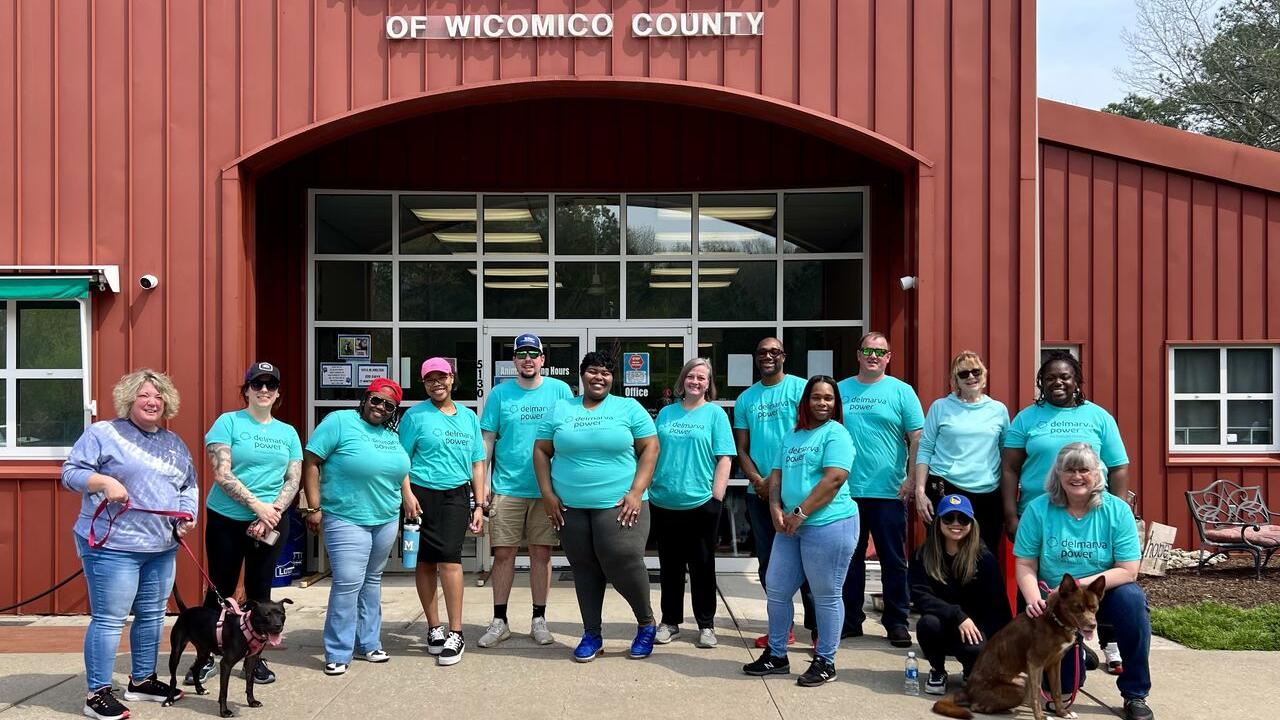  group of volunteers posed outside a building "Humane Society".