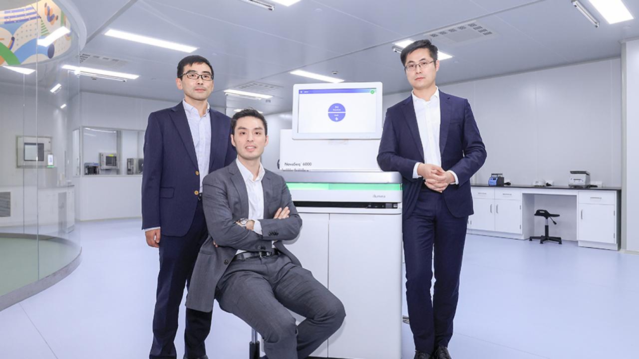 Illumina scientists in front of a computer screen.