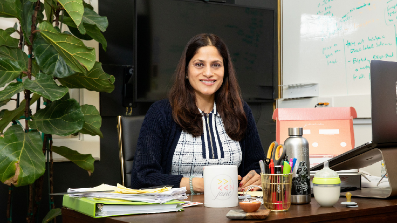 Ridhi Tariyal seated at a desk smiling.