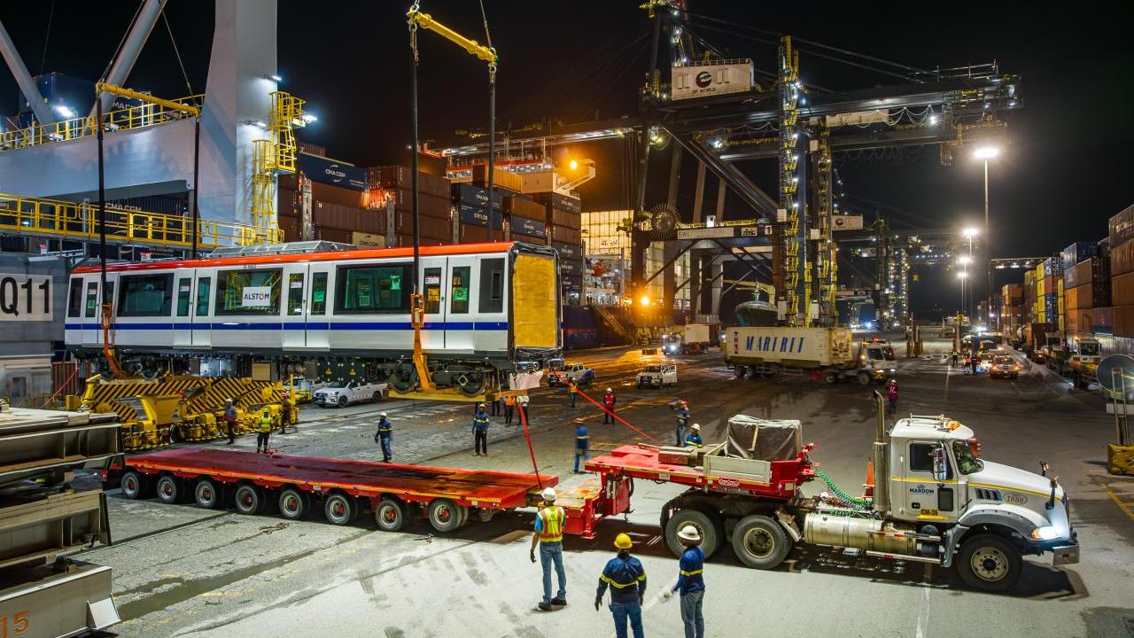 subway car getting loaded onto truck