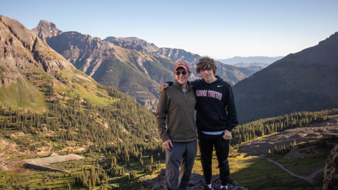 John Mulcahy and family member posed in a scenic natural area.