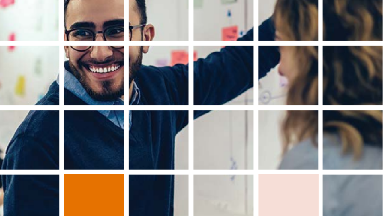 Photo of people at a white board, with a grid overlay