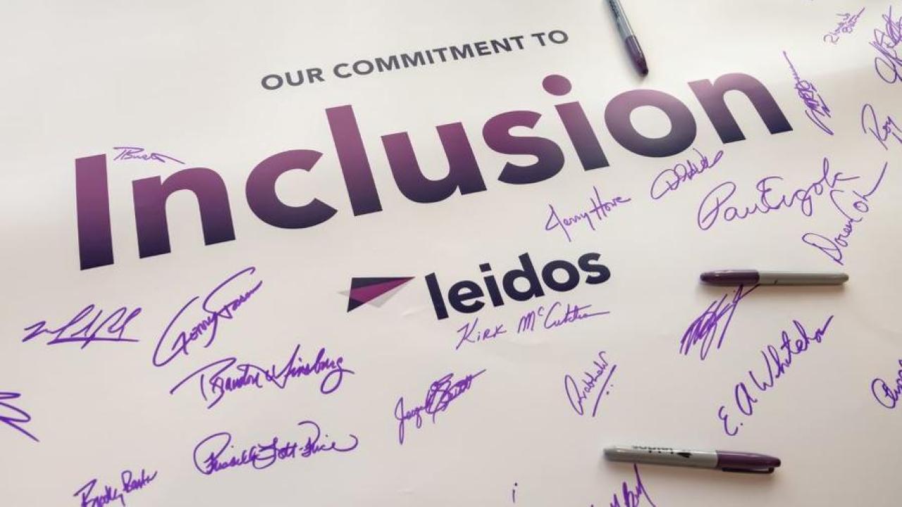 Signed poster that reads " Our Commitment to Inclusion, Leidos"