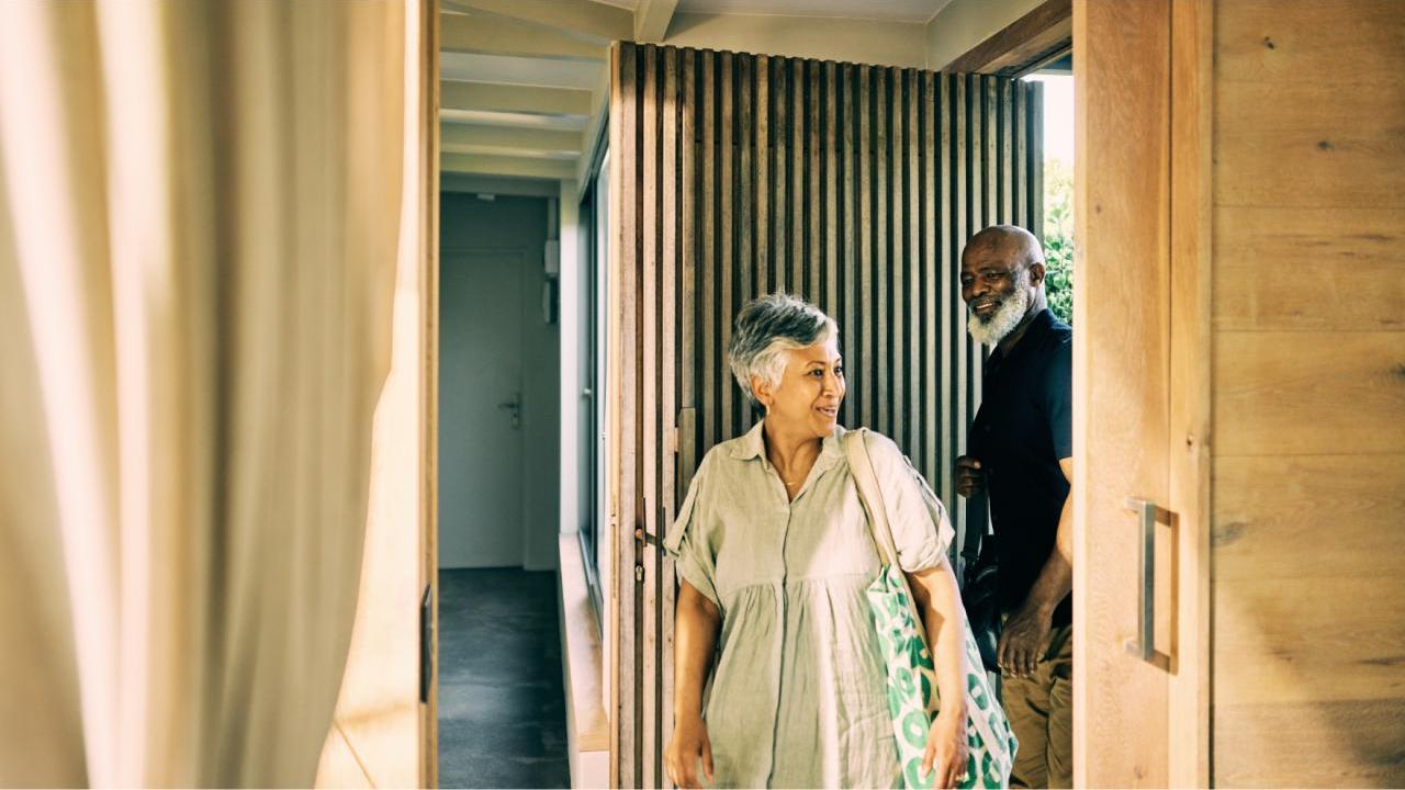 Two people entering a building 