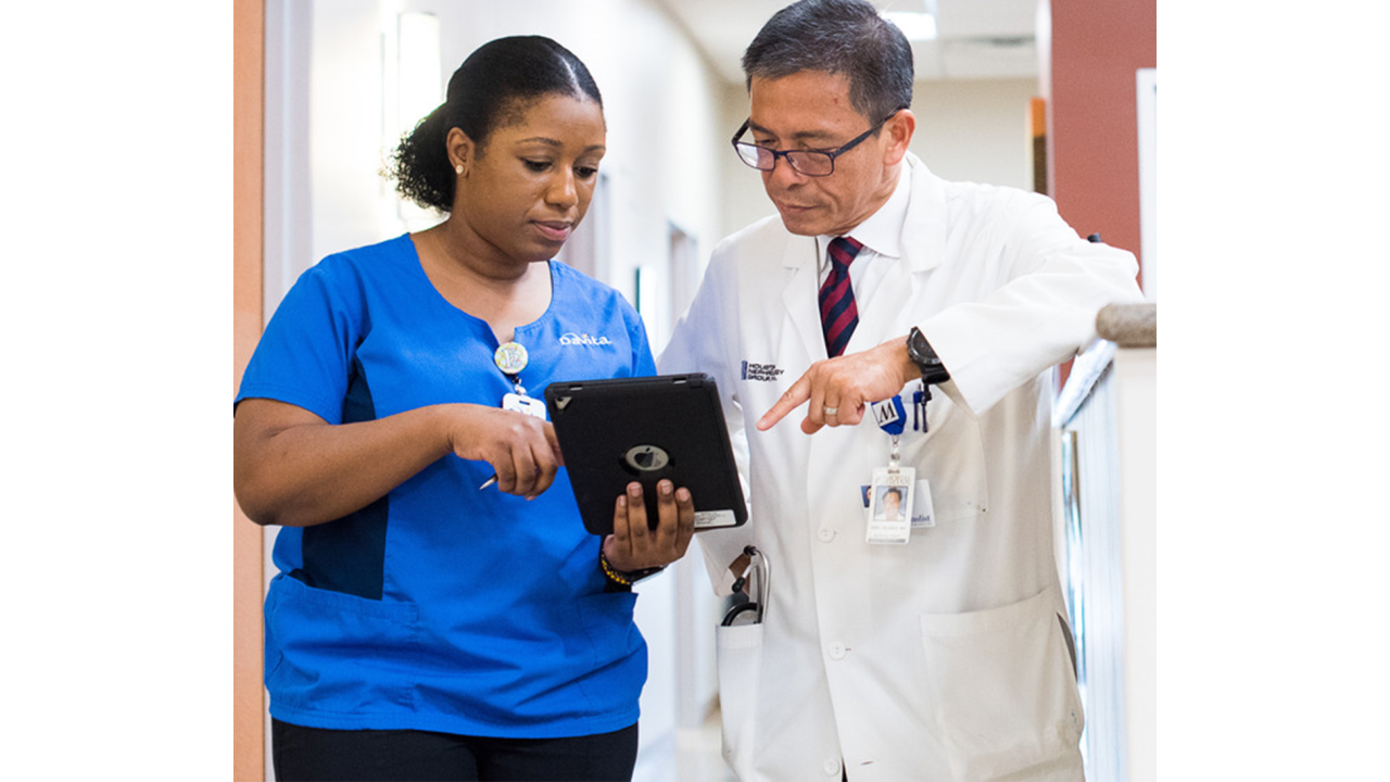 2 healthcare workers looking at a tablet