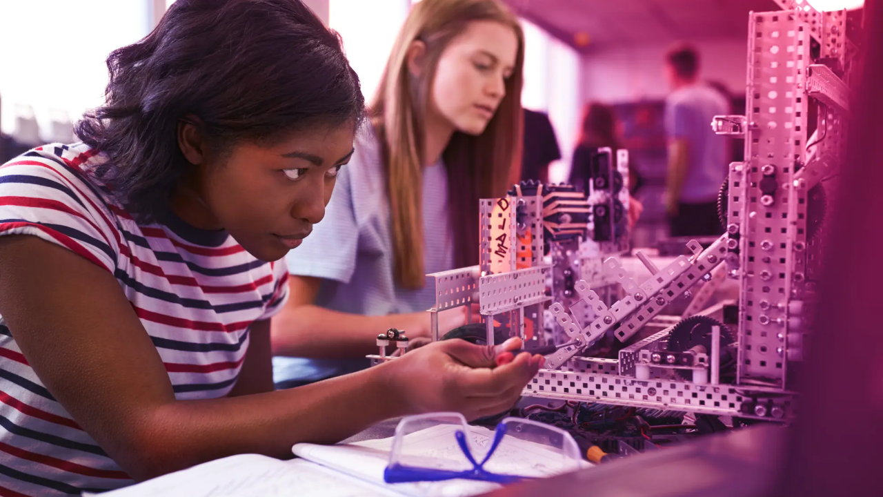 Students working on a machine