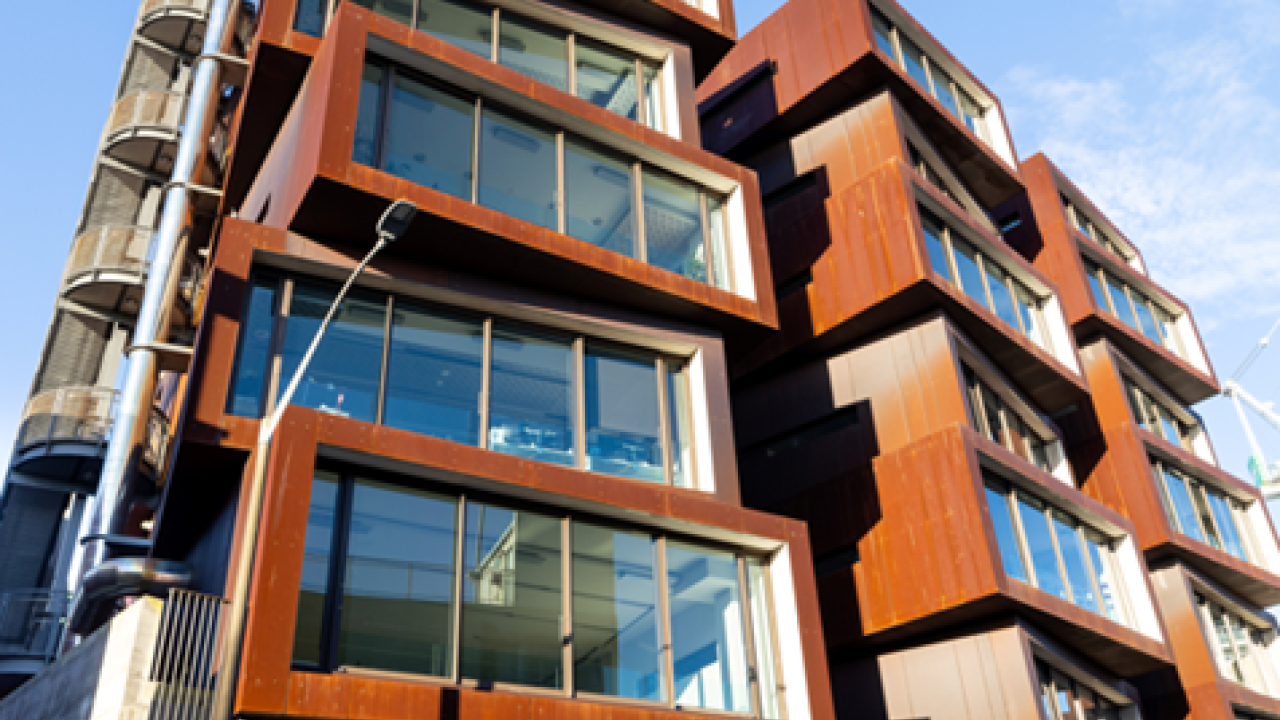 Six story angular building with weathered exterior