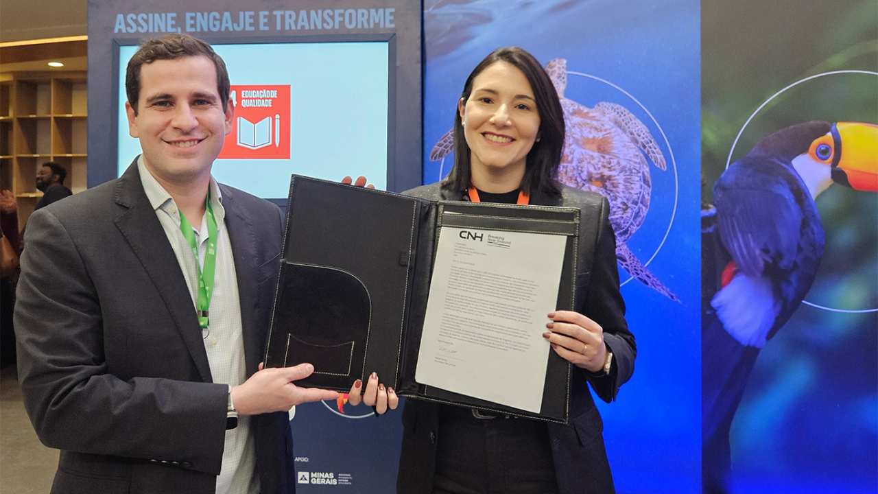 Two people holding a folder