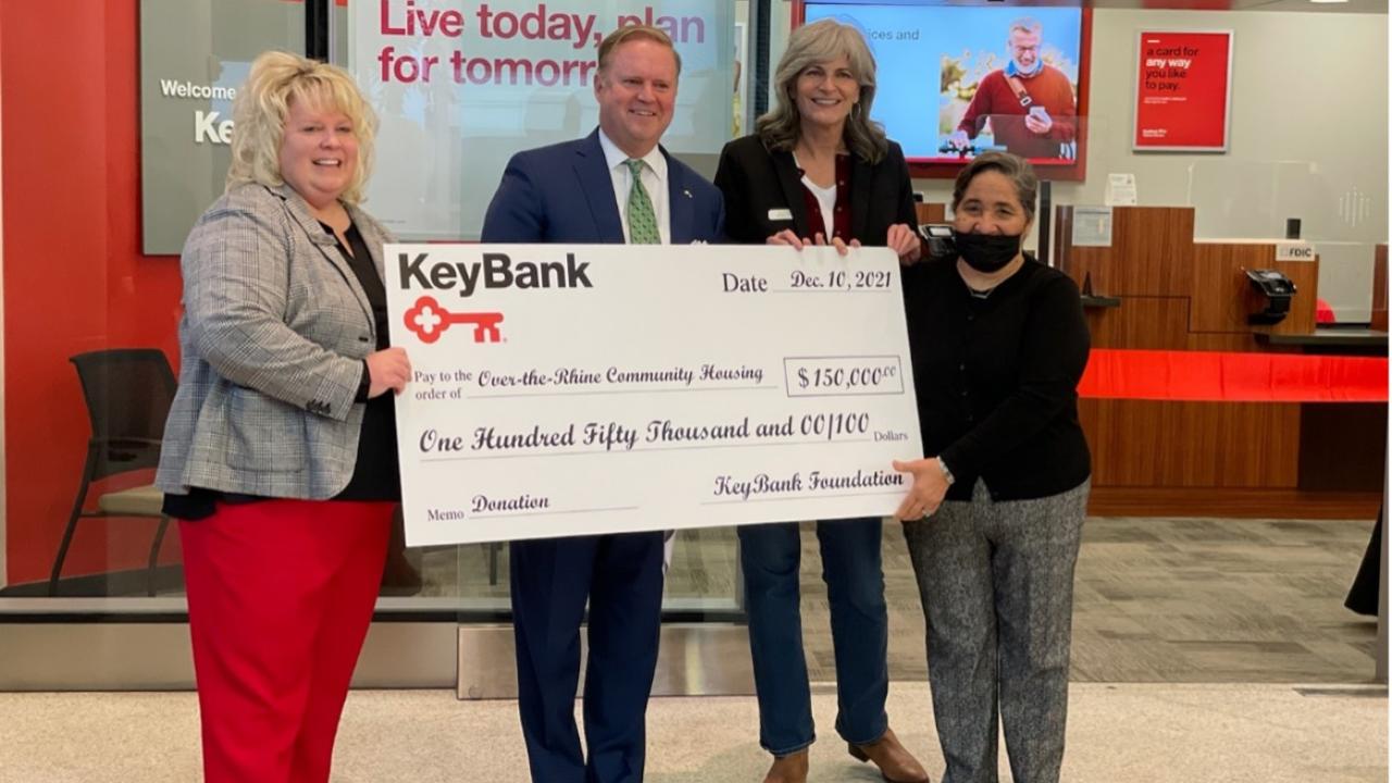(From left) KeyBank Regional Retail Leader Stacy Radabaugh and Market President Michael McCuen present a KeyBank Foundation grant of $150,000 to Over-The-Rhine Community Housing Executive Director Mary Burke Rivers and OTRCH Board Vice President Georgia Keith. Group is holding a large KeyBank check for $150,000.